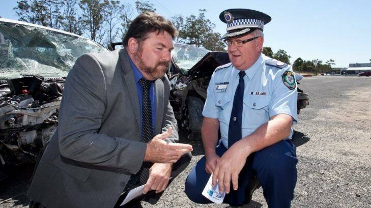 Peter Frazer and Traffic and Highway Patrol Commander John Hartley address the media with a road safety message before a long weekend last year.  Photo: Geoff Jones