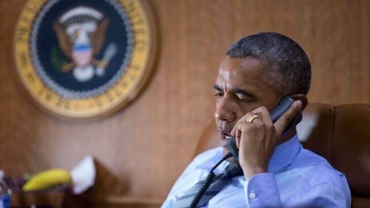 President Barack Obama talks on the phone aboard Air Force One with President Petro Poroshenko of Ukraine about the Malaysian Airlines plane crash. Photo: White House