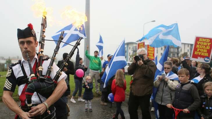 Flaming bagpipes - an image that captures the mood of the historic event. Photo: Reuters