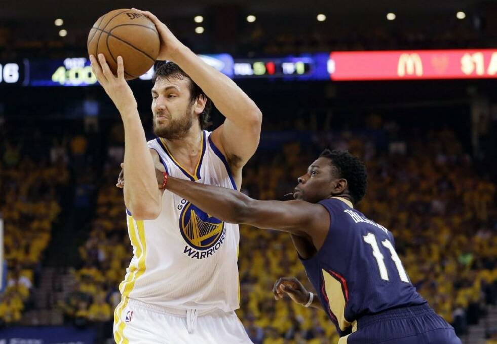 Central performer: Golden State Warriors centre Andrew Bogut  grabs a rebound next to New Orleans Pelicans guard Jrue Holiday. Photo: Marcio Jose Sanchez