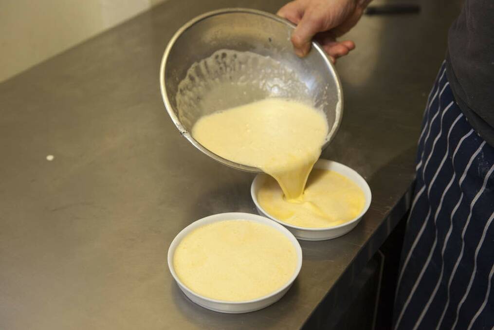 Pass the mixture through a sieve into a jug. Pour the mixture equally into six ramekins, leaving about a centimetre at the top. Photo: Glenn Hunt/Getty Images