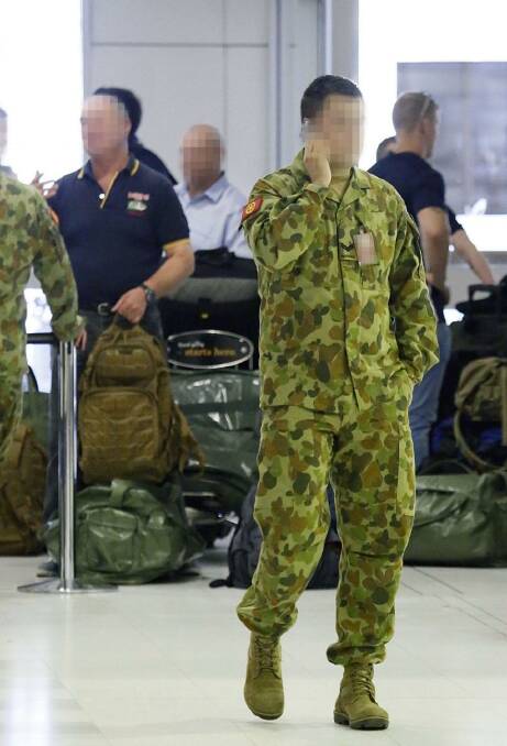 Departure: Over 80 troops checked through Sydney Airport's commercial terminal en route to Iraq. Photo: Diimex