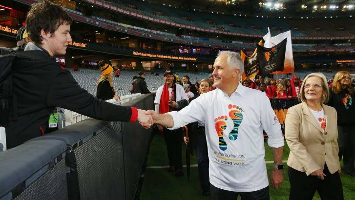 Malcolm Turnbull, with wife Lucy, shakes a Bombers fan's hand during The Long Walk before the round 10 AFL match. Photo: Michael Dodge