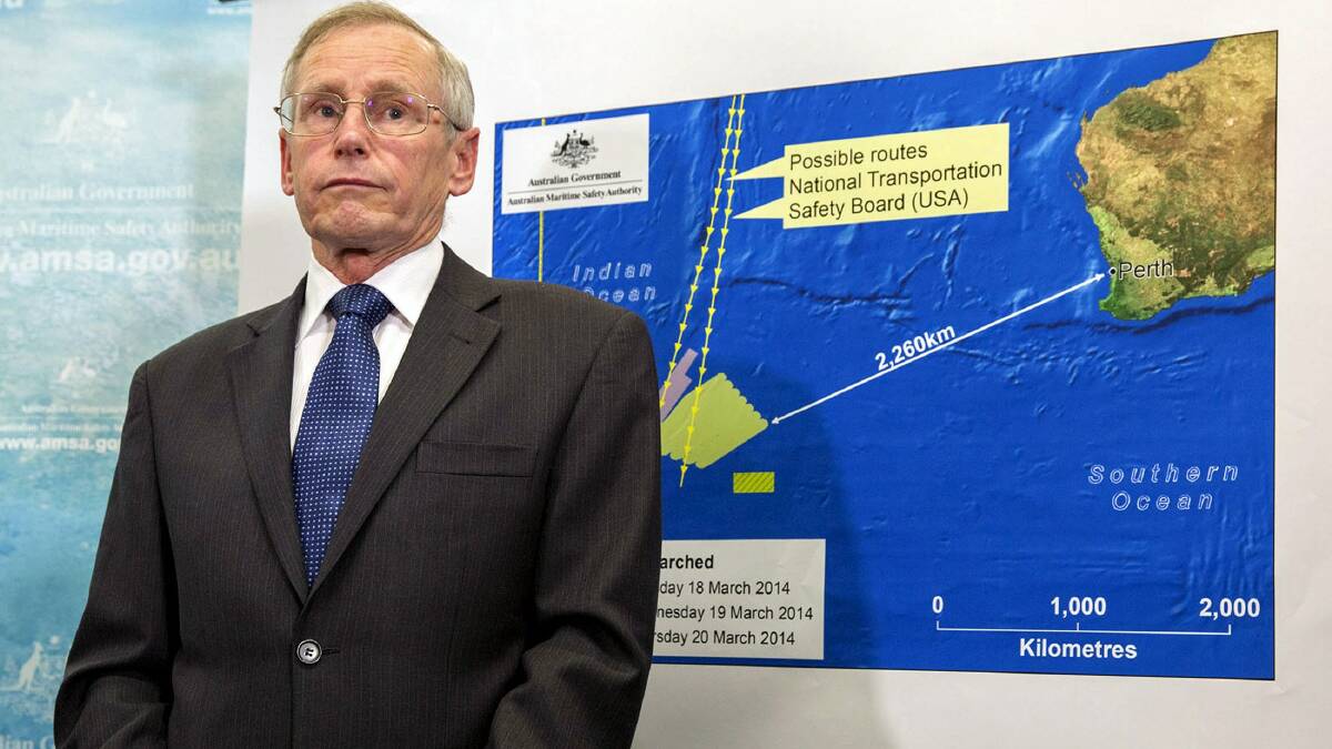 John Young, general manager of the emergency response division of the Australian Maritime Safety Authority (AMSA), listens to a question as he stands in front of a diagram showing the search area for Malaysia Airlines Flight MH370 in the southern Indian Ocean, during a briefing in Canberra March 20, 2014. Photo: Reuters.