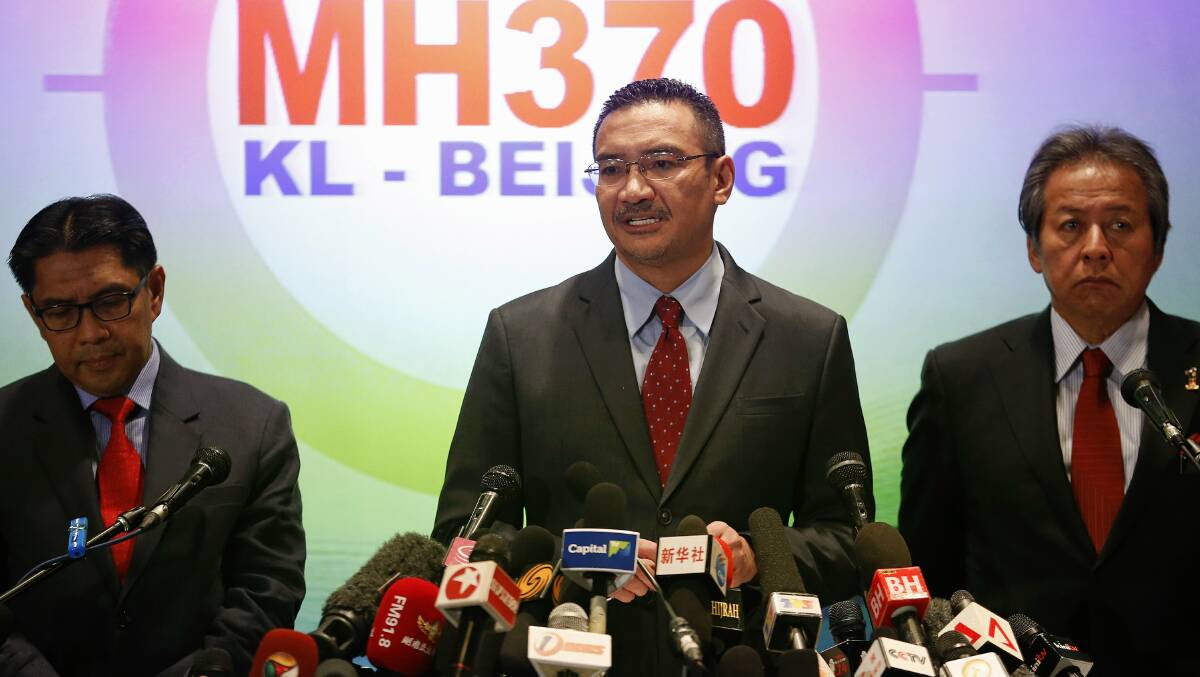 Malaysia's acting Transport Minister Hishammuddin Hussein (C) is accompanied by Foreign Minister Anifah Aman (R) and Department of Civil Aviation's Director General Azharuddin Abdul Rahman as he addresses reporters about the missing Malaysia Airlines flight MH370, at Kuala Lumpur International Airport March 20, 2014. Photo: Reuters.