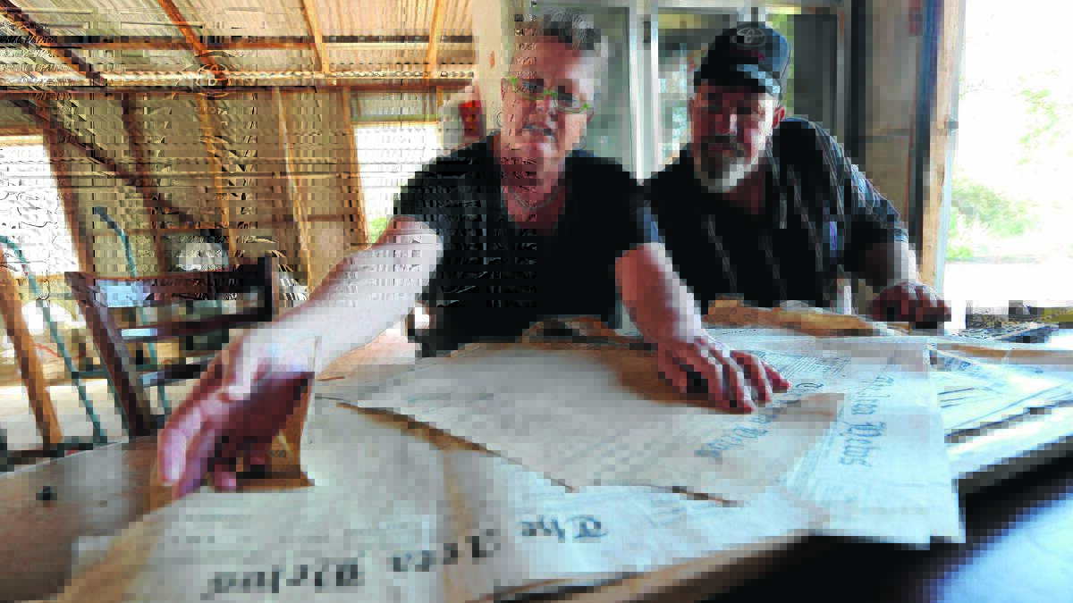 OLD NEWS: Karen Fench and Ugo Fattore read over the old newspapers 
they uncovered during renovations to their home in Merrigal Street. Picture: Anthony Stipo
