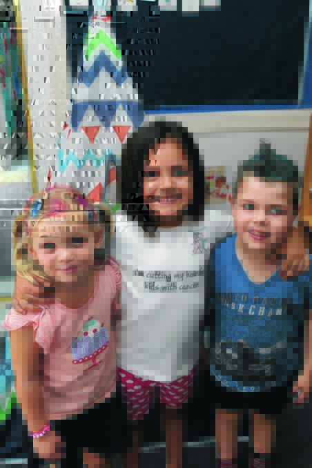 HAIR-RAISING: Zara Tagliapetra, 4 and Jack Webb, 4, embrace Crazy Hair Day at Griffith Kindergarten Preschool yesterday to show support for their friend Olivia Cappello (middle), who cut her hair to be made into a wig for cancer patients. Picture: Anthony Stipo