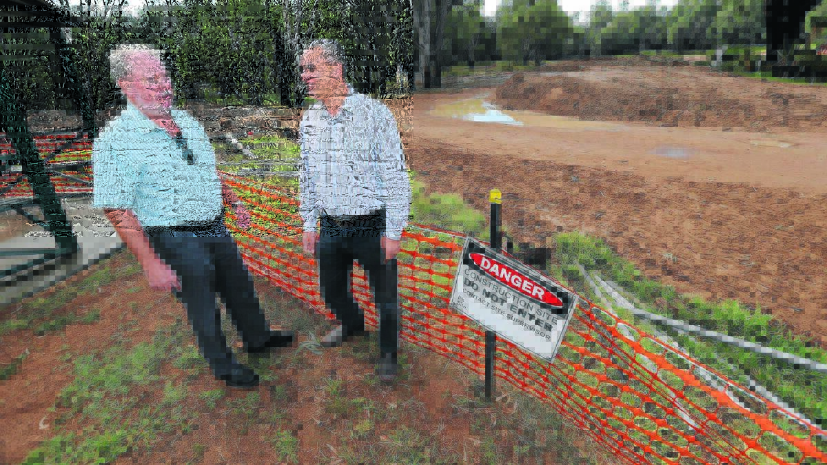 FLOW ON:  Murrumbidgee Shire mayor Phil Wells and council’s Joseph Bianchini check out the progress being made on the Darlington Point levee construction. 	             Picture: Anthony Stipo 