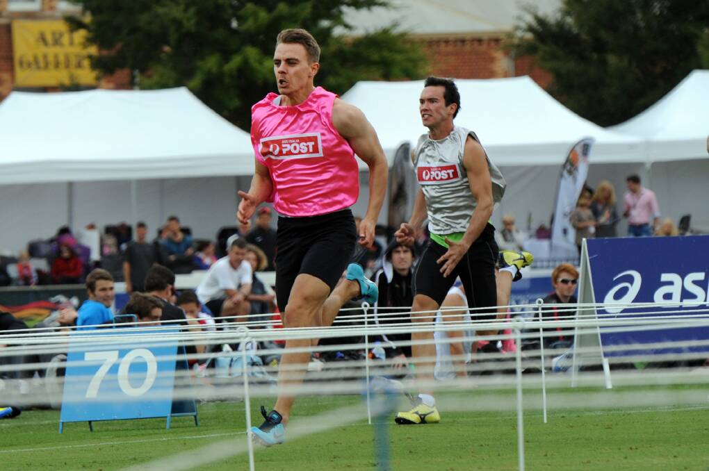 Augustine Carty-Cowling, pink, wins heat 8 of the 2014 Stawell Gift. 