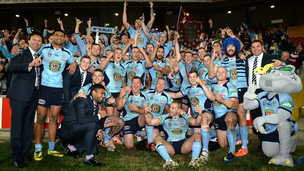 Blues players celebrate their series win after game three of the State of Origin series between the Queensland Maroons and the NSW Blues at Suncorp Stadium on July 9, 2014 in Brisbane, Australia. Pic: Bradley Kanaris/Getty Images