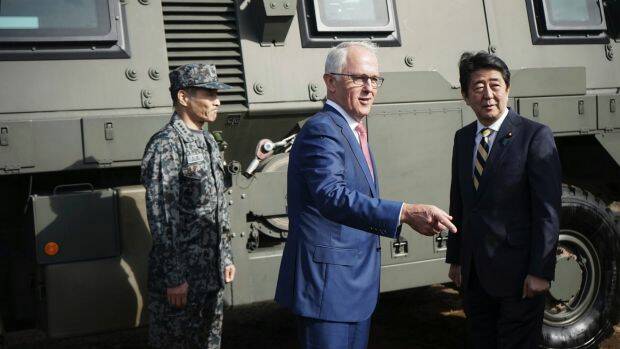 Australian Prime Minister Malcolm Turnbull, centre and Japanese counterpart Shinzo Abe at Narashino Exercise Area east of Tokyo on Thursday. Photo: AP