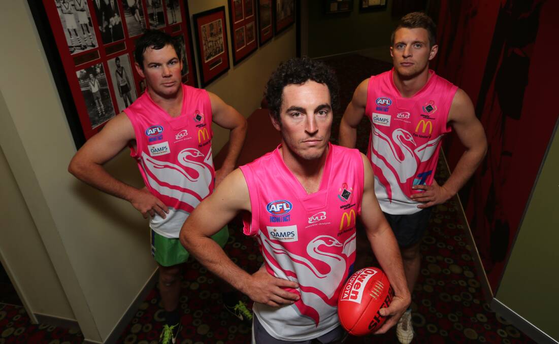 FOR A GOOD CAUSE (from left): James Fallon, Jono Gastin and James Toscan try out Griffith's pink round guernseys, to be worn tomorrow afternoon against GGGM.