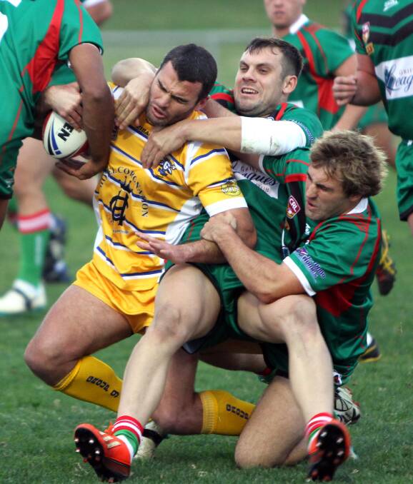 CRUNCH TIME: Group Nine's Daniel Fitzhenry is tackled by Group 20 prop Tom Sellars and fullback BJ Kerry on Saturday. Sellars is one of six Razorbacks to have earned a spot in the Riverina side, which will be coached by Fitzhenry at the CRL Country Championships later this month. Picture: The Daily Advertiser