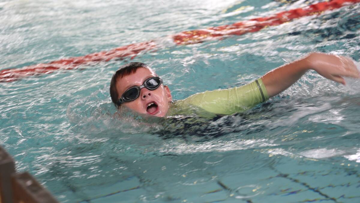 BREATHE IN: Xavier Chirgwin, 9, sucks in the big ones during his race at the MIA Deanery swimming carnival.