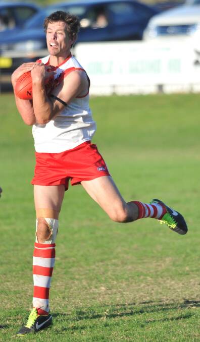 STANDING TALL: Michael Griffiths snaps up a chest mark during Sunday's narrow four-point loss to Coolamon.
