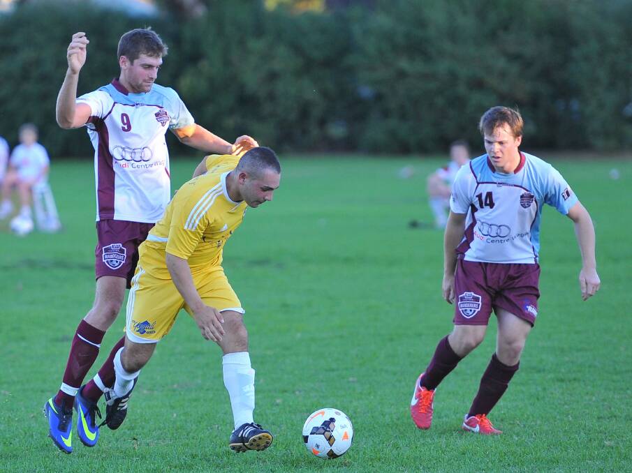 CLOSE ATTENTION: YFC's Pasquale Madaffari fends off this challenge from Eastern Wanderers star Sam Mangelsdorf on Saturday at Gissing Oval.