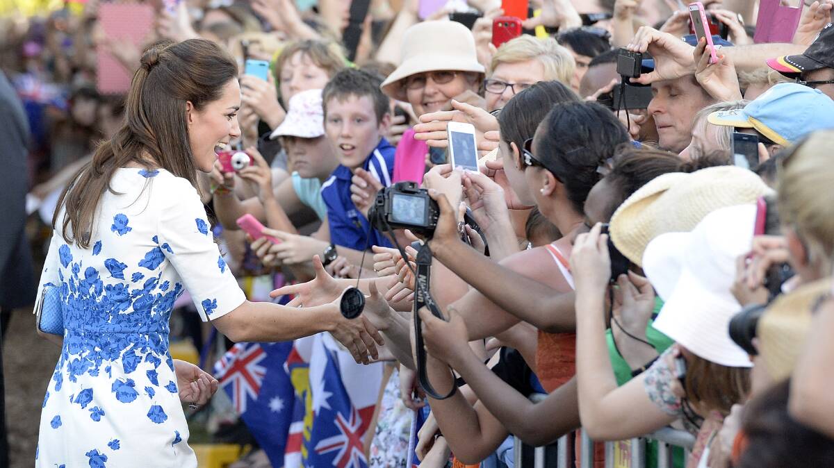  Catherine, Duchess of Cambridge shakes hands with a member of the public on the Brisbane walkabout.  (Photo by Bradley Kanaris/Getty Images)