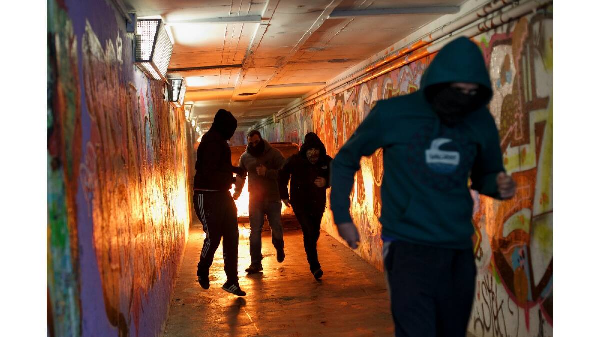 Protesters run away from a bin that they set fire to in an undergrounf passage during a protest against the government's education reforms and cutbacks in university grants and staffing in Campus Ciudad Universitaria on March 26, 2014 in Madrid, Spain. Photo: Getty Images.