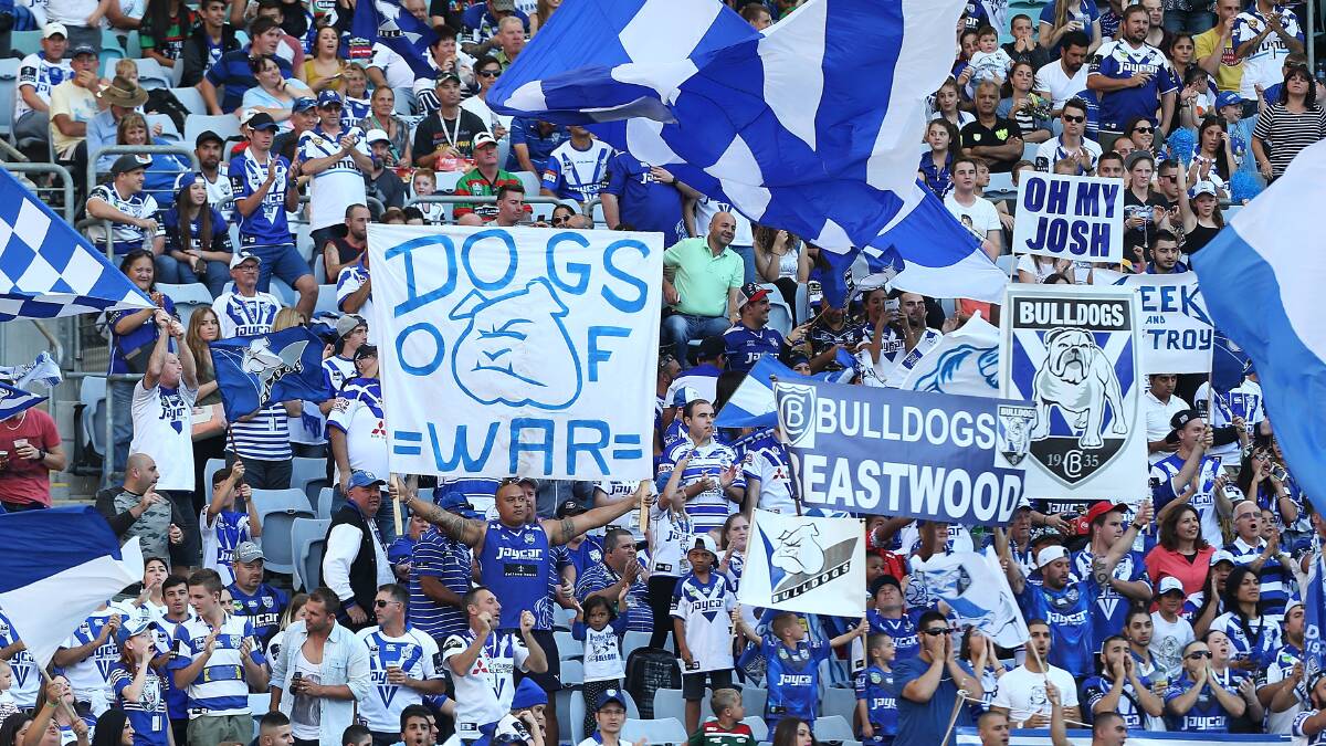 Bulldogs fans celebrate a try during the round seven NRL match between the South Sydney Rabbitohs and the Canterbury-Bankstown Bulldogs at ANZ Stadium on April 18, 2014 in Sydney, Australia. Photo: Mark Metcalfe/Getty Images.