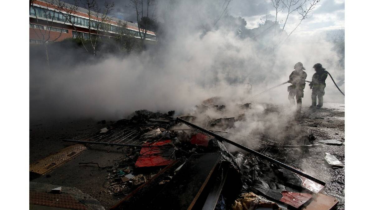 Firemen extinguish a burning barricade during a protest against the government's education reforms and cutbacks in university grants and staffing in Campus Ciudad Universitaria on March 26, 2014 in Madrid, Spain. Photo: Getty Images.