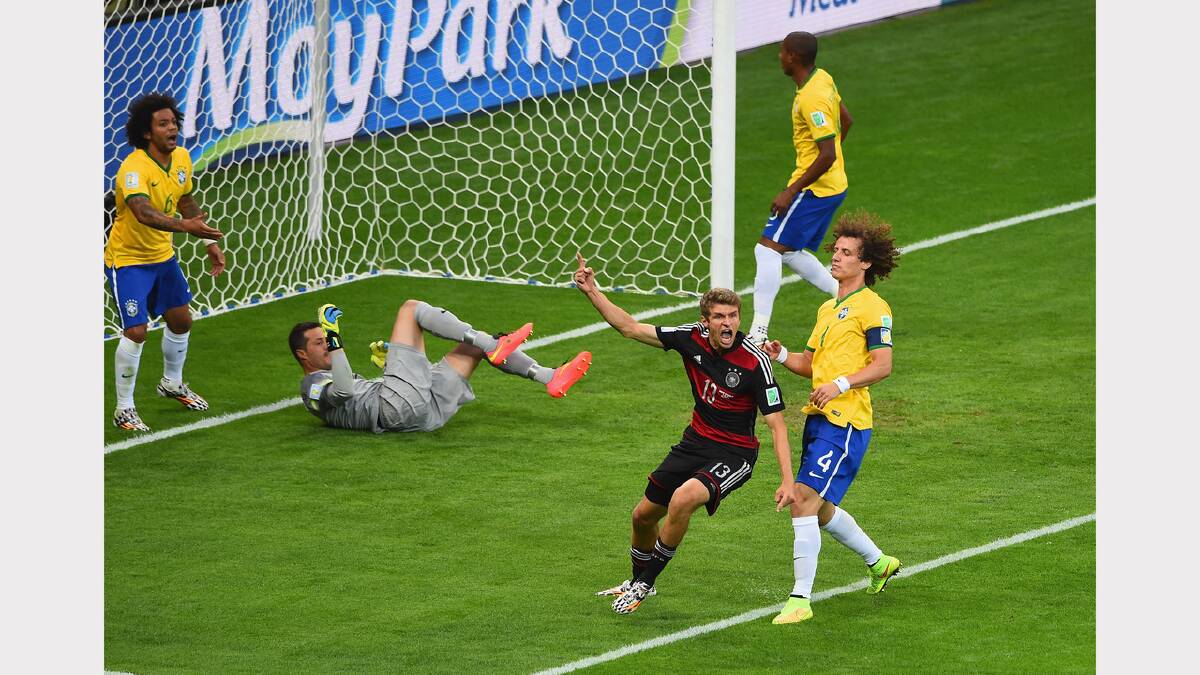 Thomas Mueller of Germany celebrates scoring his team's first goal past Julio Cesar of Brazil during the 2014 FIFA World Cup Brazil Semi Final match between Brazil and Germany at Estadio Mineirao on July 8, 2014 in Belo Horizonte, Brazil.  (Photo by Jamie McDonald/Getty Images)	
