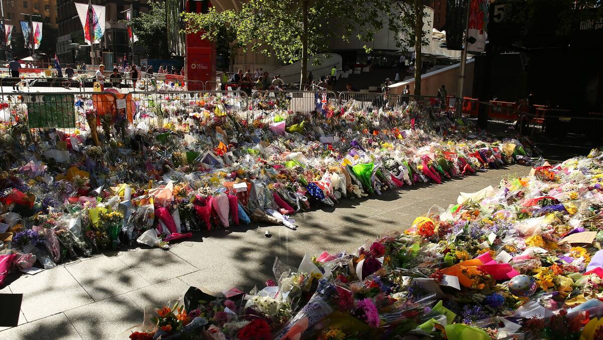 SEA OF FLOWERS: Floral tributes cover Sydney's Martin Place where hostages Tori Johnson and Katrina Dawson lost their lives.