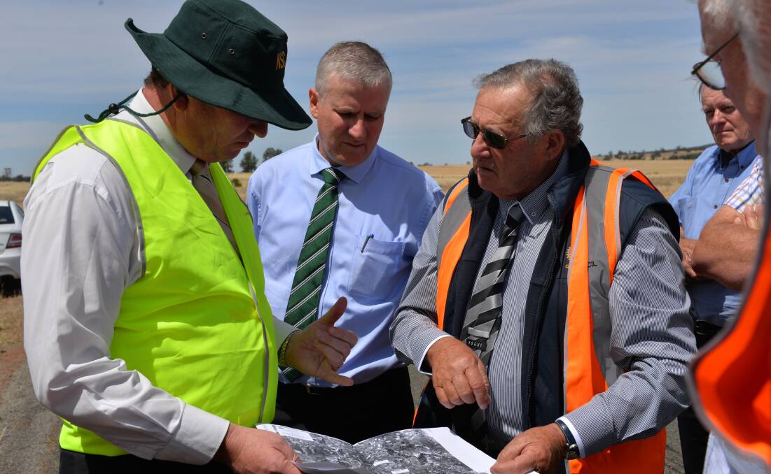 WORTH EXPLORING: Agriculture Minister Barnaby Joyce reviews plans for a dam at Lake Coolah with Member for Riverina Michael McCormack and Griffith mayor John Dal Broi.