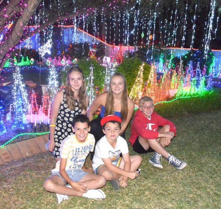 IT'S STARTING TO LOOK LIKE CHRISTMAS: Zarah Sully, 14, Natasha Nancarrow, 15, Jeffery Johnson, 11, Corey Charles, 8, and Connor Sully, 11, love the Christmas lights at Holmes Crescent.
