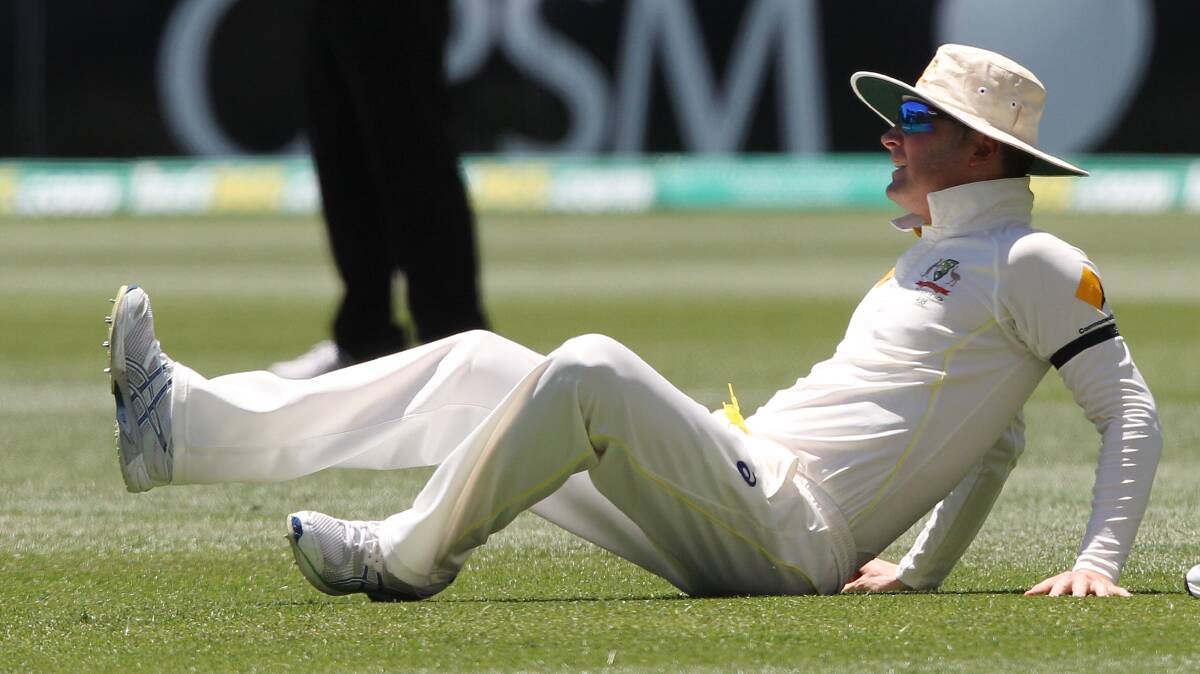 IN PAIN: Aussie captain Michael Clarke falls to the ground after hurting his hamstring in the first Test against India in Adelaide. Picture: AP Photos