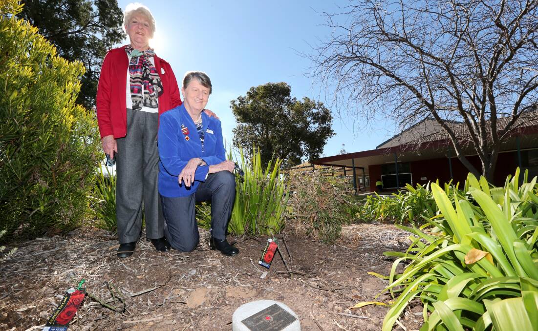 MIILESTONE: Coleambally Red Cross president Joyce Chirgwin and Red Cross zone 25 representative Denny Scott plant a rose to mark 100 years of Red Cross. Picture: Anthony Stipo