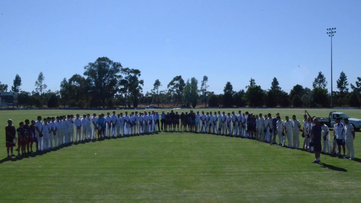UNITED FRONT: Players pause for a minute of silence before the start of the NSW Country Championships at Exies Oval.