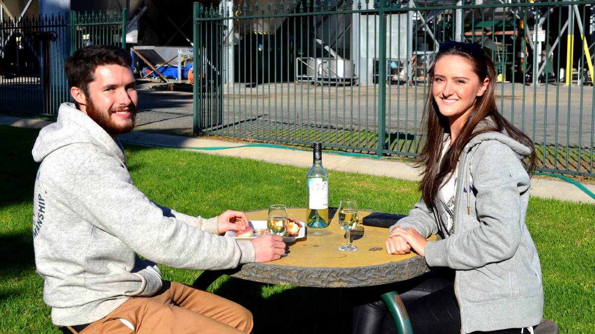 RELAX AND UnWINEd: Thomas Atkinson and Stephanie Norman made the most of the warm weather at McWilliam's Hanwood Estate on Saturday.