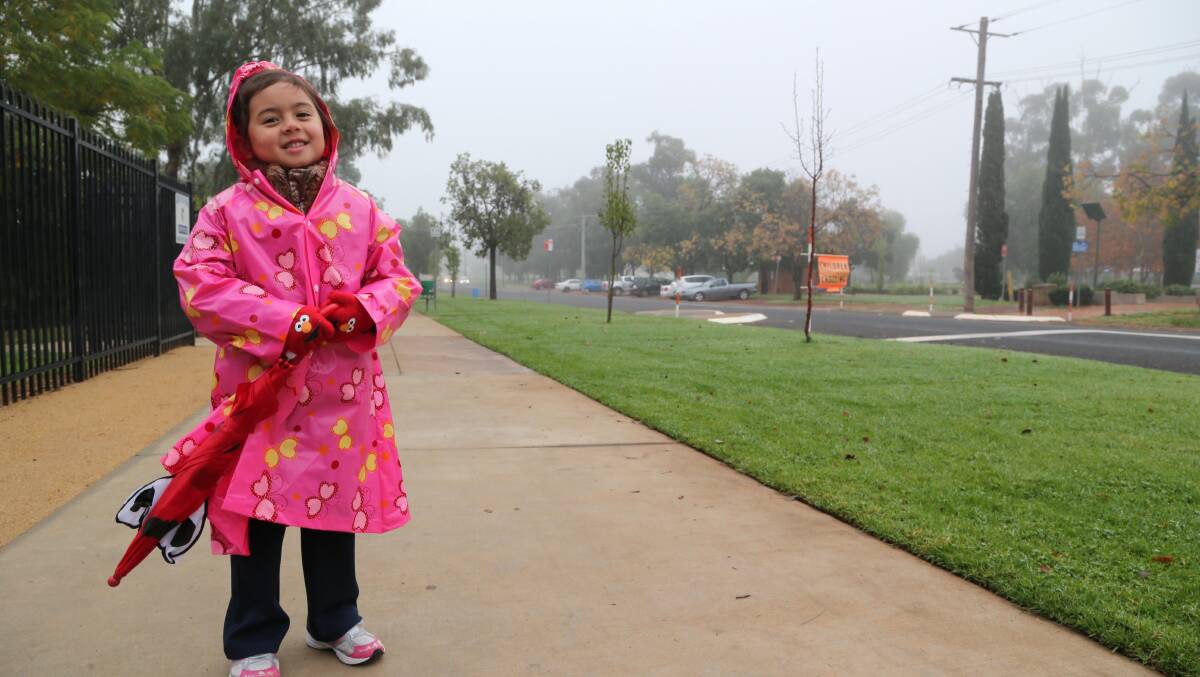 RUGGED UP: Annie Marie Perre, 5, was prepared for the second day of winter as she made her way to school on Monday. Picture: Anthony Stipo.