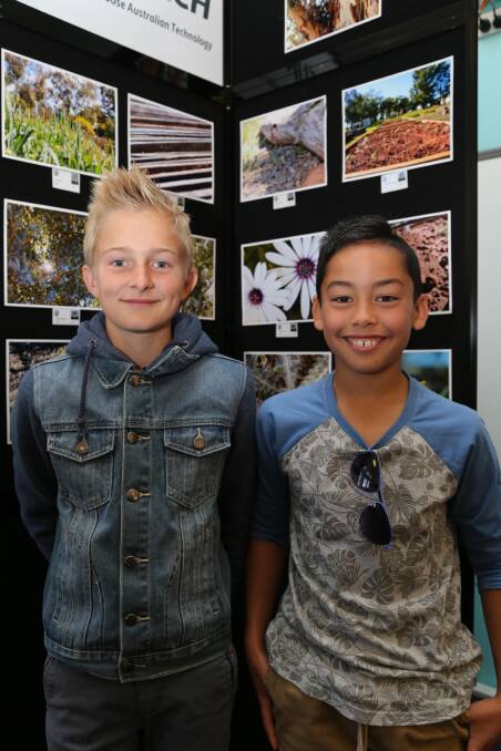 IN FOCUS: William Polkinghorne, 11, and Zack Hutchinson, 11, check out the photos on display at the Lake Wyangan Public School Photography Festival on Saturday. Picture: Anthony Stipo