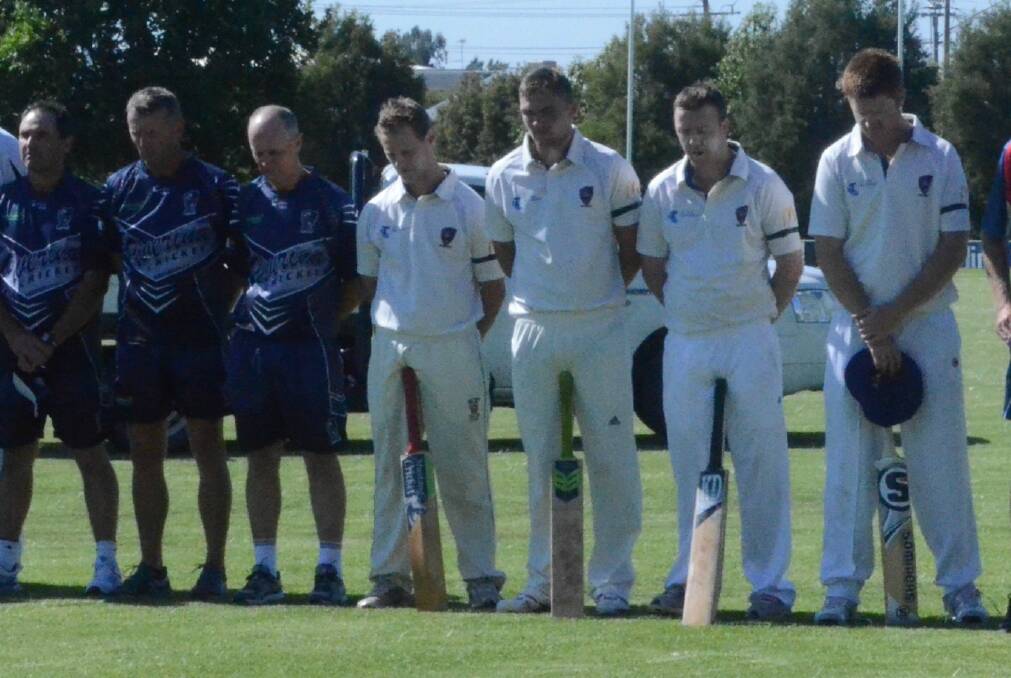 MARK OF RESPECT: Jordan Moran, fourth from the left, joins cricketers at Exies Oval in a minute's silence following the death of Phillip Hughes.