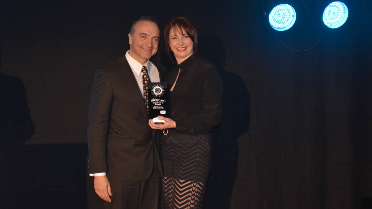 LEADER IN THE FIELD: Flavourtech chief executive officer Kon Gryllakis accepts the award for excellence in export from NSW Business chamber board member Ellie Brown.