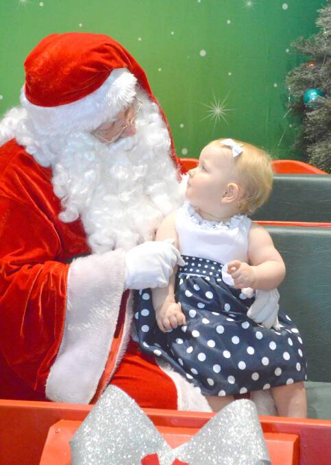 HO HO HO: One-year-old Ariya Smith tells Santa what she wants for Christmas. Kids can still see Santa at Griffith Central today, Tuesday and Wednesday between 11am and 2pm.