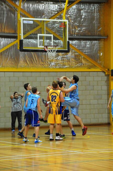 SCRAMBLE: Griffith and Narrandera players fight for the ball under the basket in their MIA League clash. Picture: Narrandera Argus.