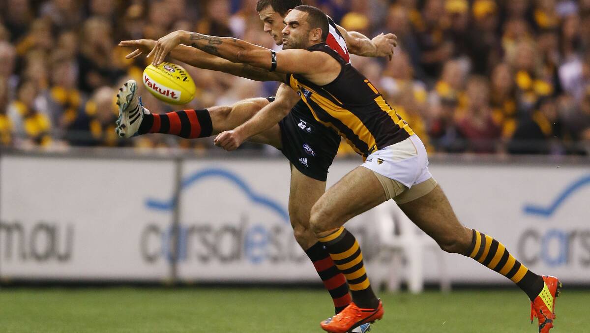 Shaun Burgoyne of the Hawks smothers the kick by Brent Stanton of the Bombers. Picture: Getty