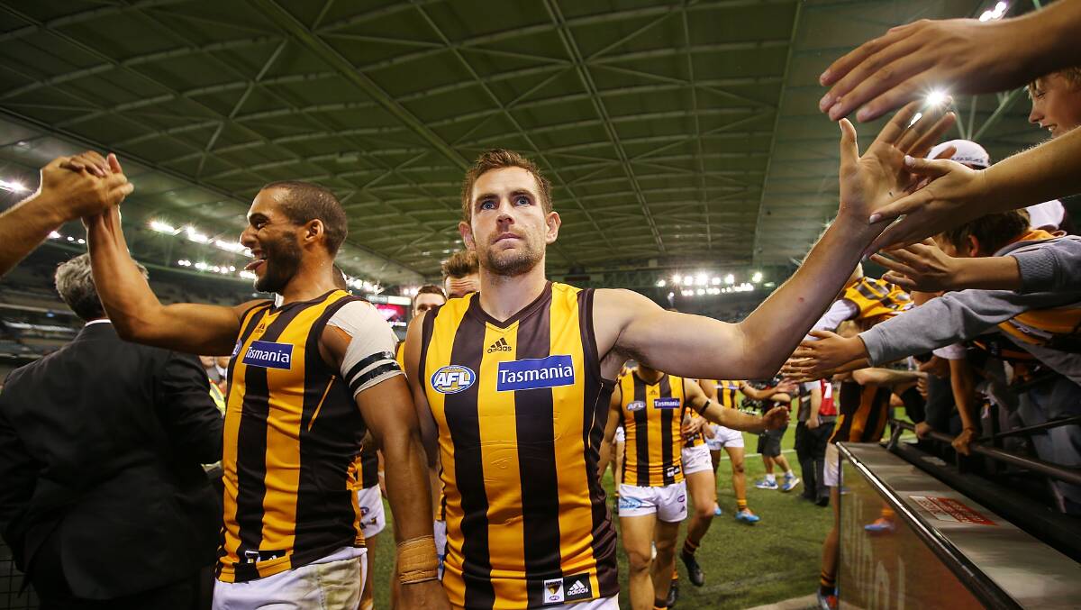 Josh Gibson (L) and Luke Hodge of the Hawks celebrate their win during the AFL Round two match. Picture: Getty