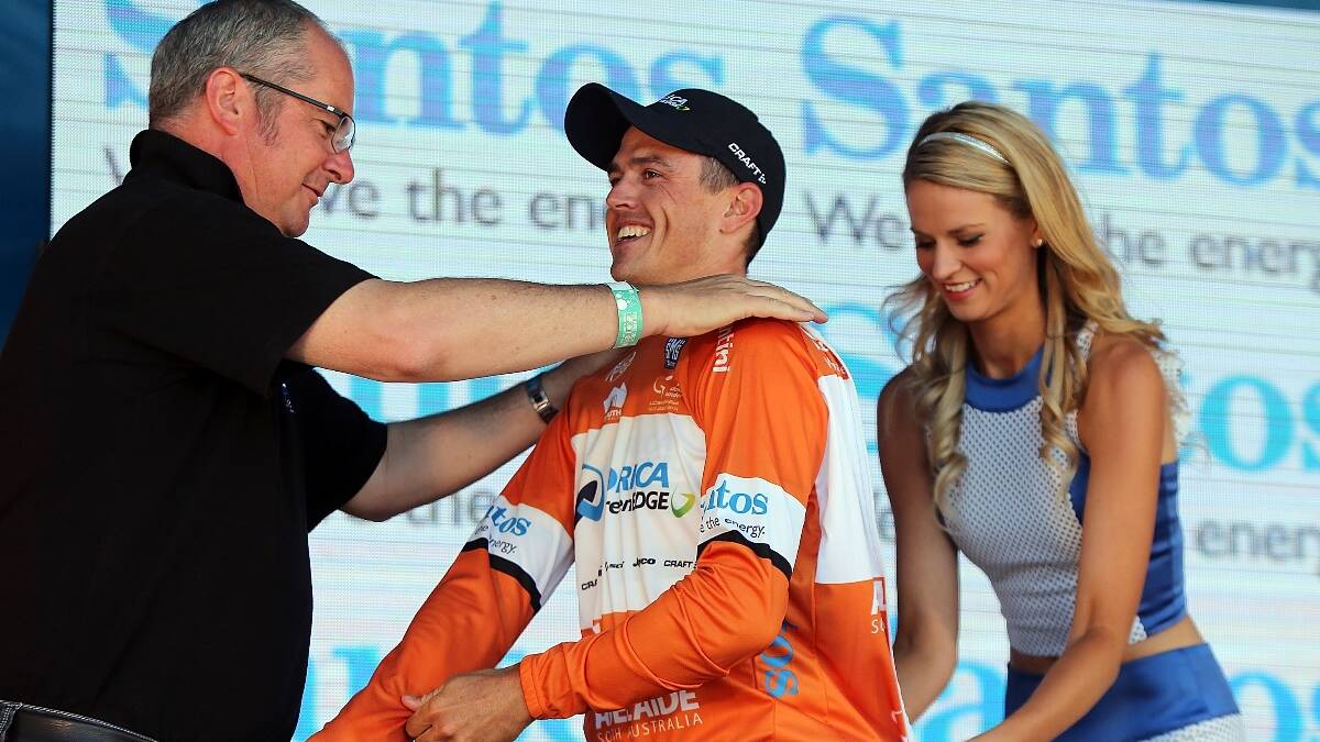 Australian cyclist Simon Gerrans of the Orica GreenEDGE team is presented with the leaders Ochre Jersey after Stage Five of the Tour Down Under. Photo: Getty.
