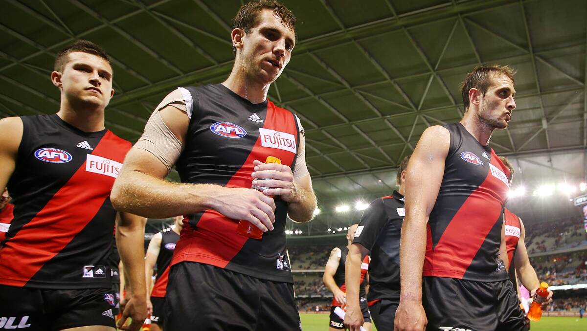 Jackson Merrett,  Kyle Hardingham and Jobe Watson walk off after their defeat during the AFL Round two match between the Essendon Bombers and the Hawthorn Hawks. Picture: Getty