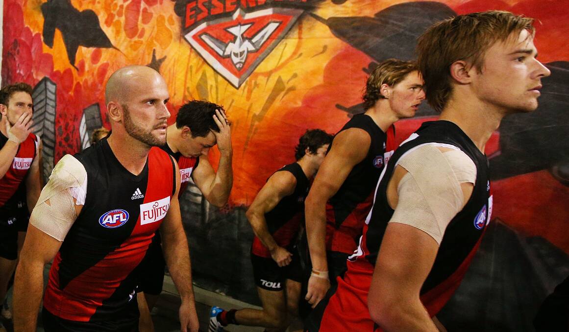 Paul Chapman and Martin Gleeson of the Bombers walk out to the ground during the AFL Round two match between the Essendon Bombers and the Hawthorn Hawks. Picture: Getty
