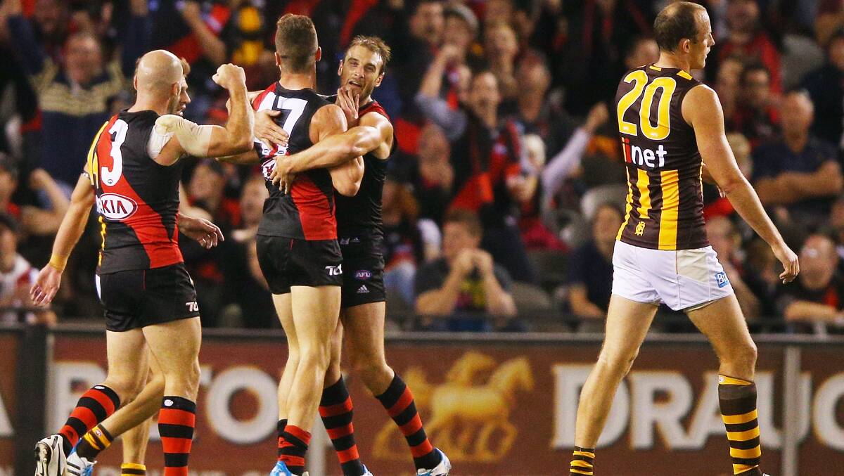Patrick Ambrose (C) and Jobe Watson (R) of the Bombers celebrate a goal during the AFL Round two match between the Essendon Bombers and the Hawthorn Hawks. Picture: Getty