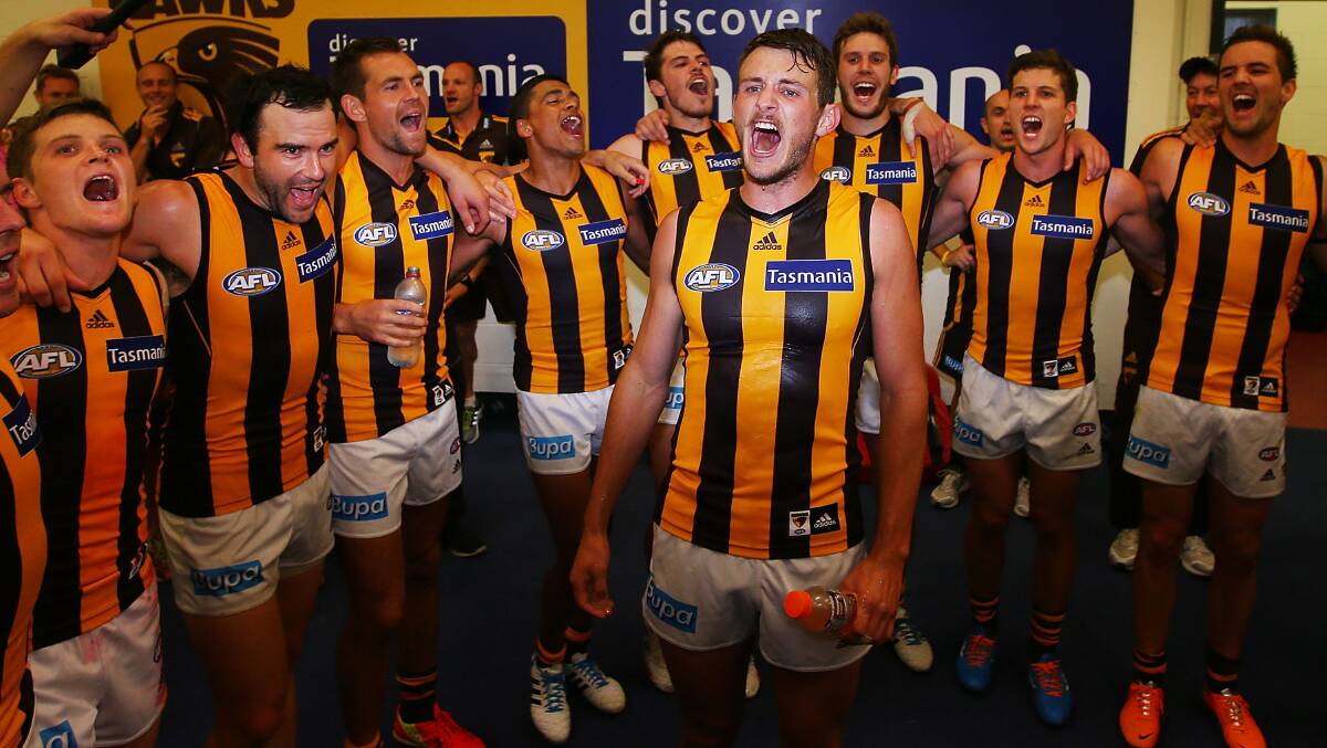 Angus Litherland of the Hawks celebrates this first win with teamates during the AFL Round two match between the Essendon Bombers and the Hawthorn Hawks. Picture: Getty