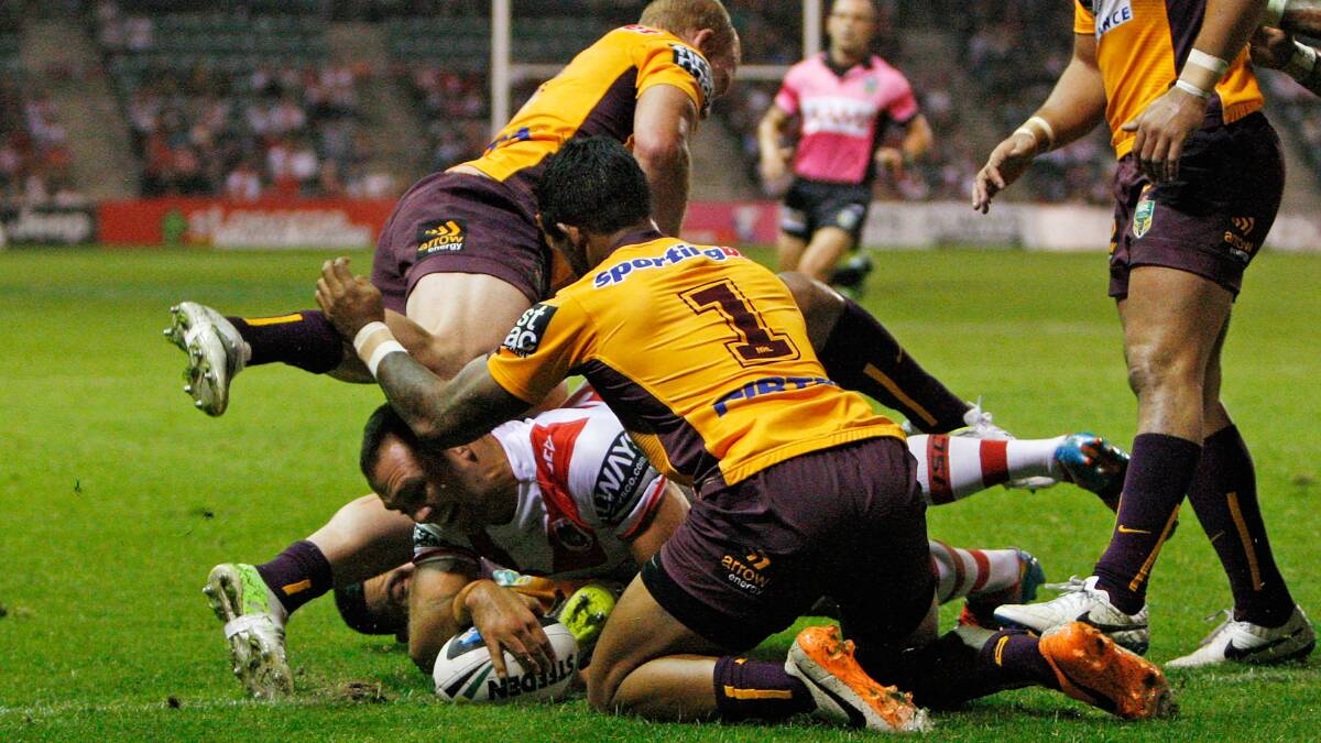 Jason Nightingale of the Dragons scores a try in the tackle of Jack Reed and Ben Barba during the round four NRL match between the St George Illawarra Dragons and the Brisbane Broncos at WIN Stadium on March 28. Picture: Getty