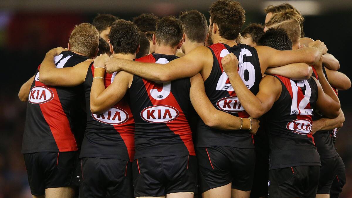 Bombers players huddle during the AFL Round two match between the Essendon Bombers and the Hawthorn Hawks. Picture: Getty
