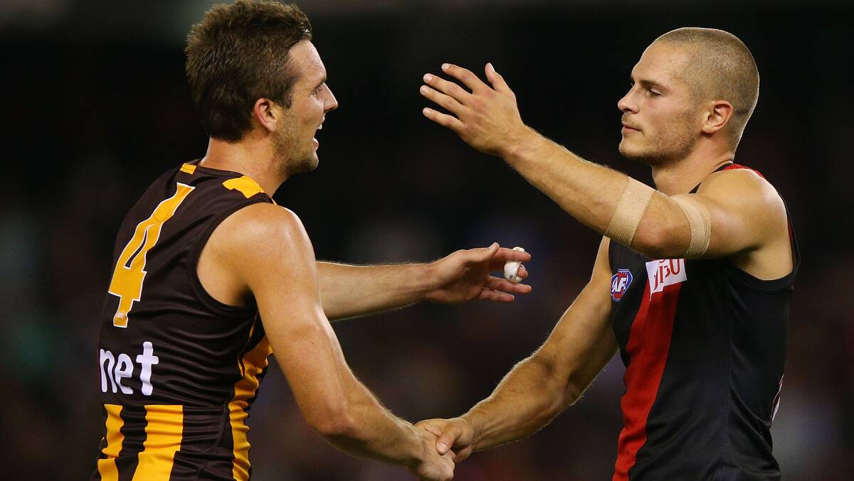 Matt Sucking of the Hawks and David Zaharakis of the Bombers shake hands after the Bombers were defeated in the AFL Round two match. Picture: Getty