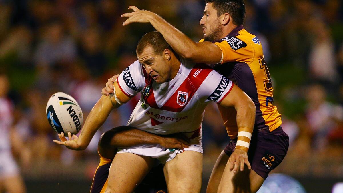 Trent Merrin gets a pass away as he is tackled by Matt Gillett. Picture: Getty