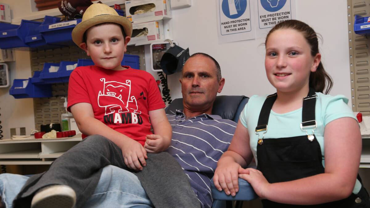 FAMILY MAN: Yenda high school teacher John Millis is joined by his youngest children John, 7, and Sophie, 9, while he gives blood for the last time at the Griffith donor centre. Picture: Anthony Stipo